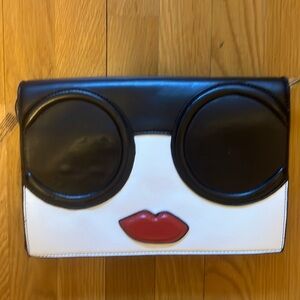Black clutch with Faux Stacy face like flap
